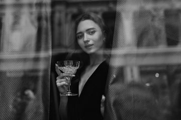 Elegant woman holds martini glass